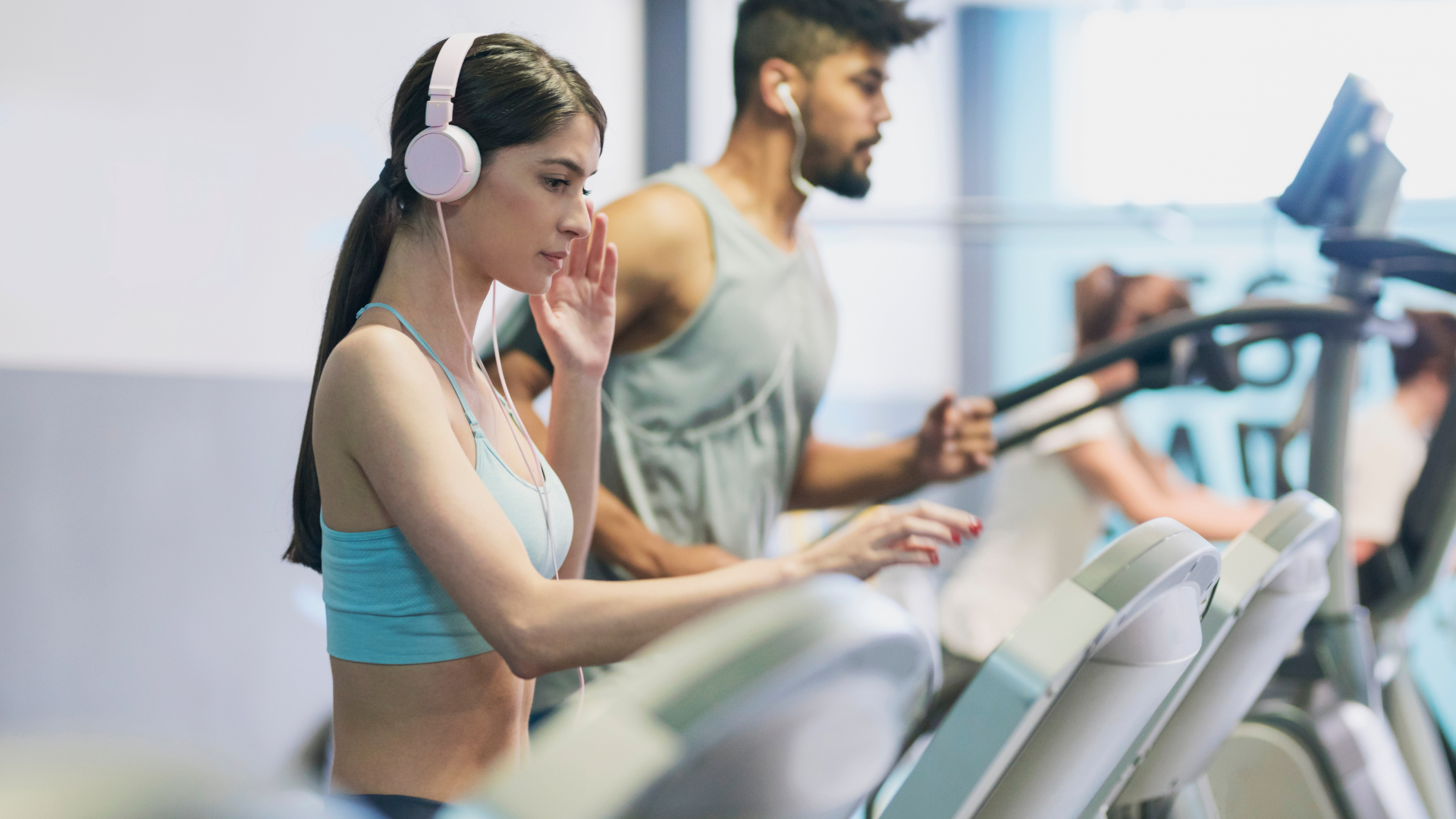 Woman Running on Treadmill Wearing Headphones